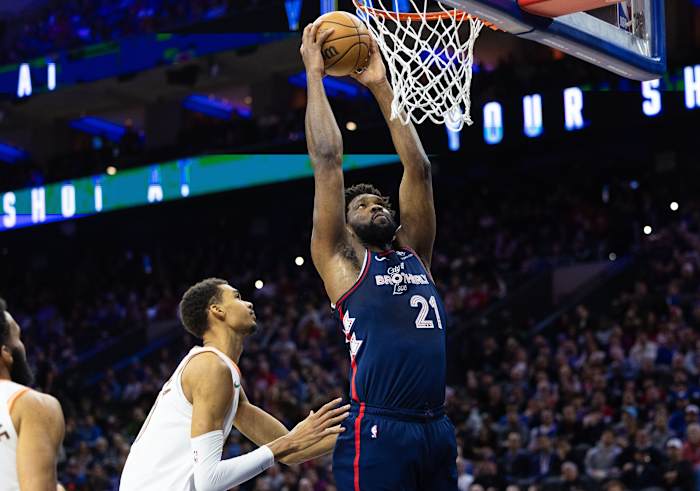 76ers center Joel Embiid scores past San Antonio Spurs center Victor Wembanyama (1) during the first quarter at Wells Fargo Center.